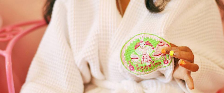 girl with multicolor nails holding a spartea cookie