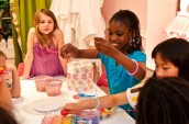 a group of girls busy beading