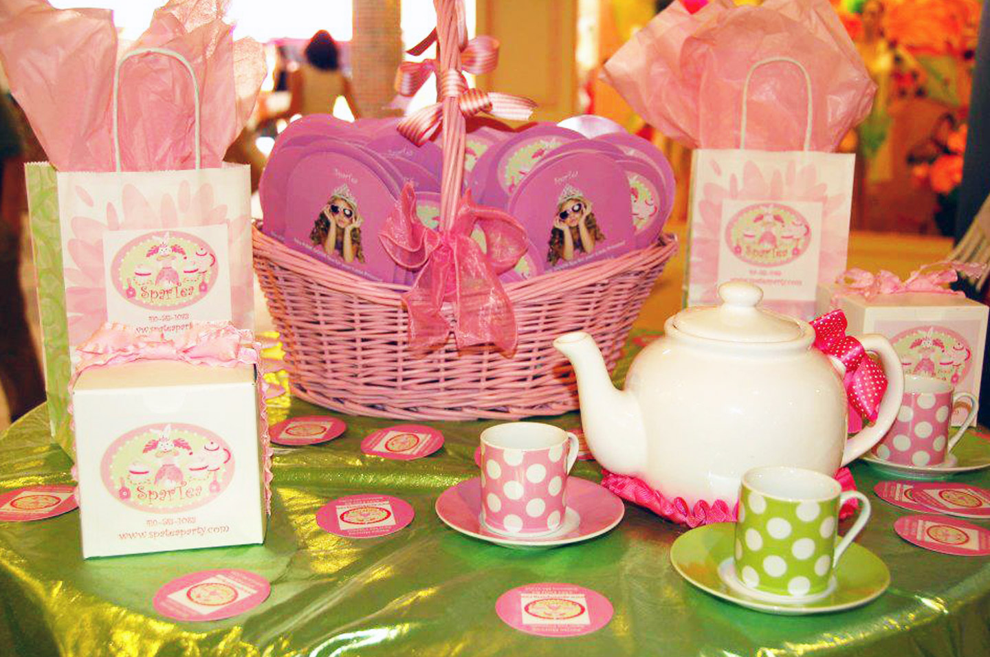 a kiddie tea set in front of a picnic basket