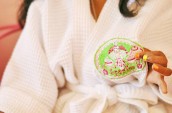 girl with multicolor nails holding a spartea cookie