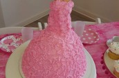 a cake with a barbie dressed in icing