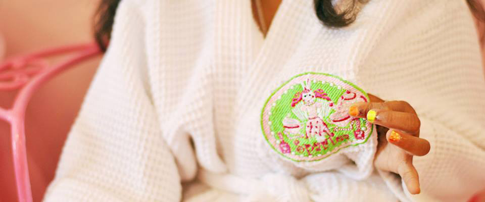 girl with multicolor nails holding a spartea cookie