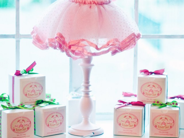 gift boxes under a lamp with a tutu looking lampshade