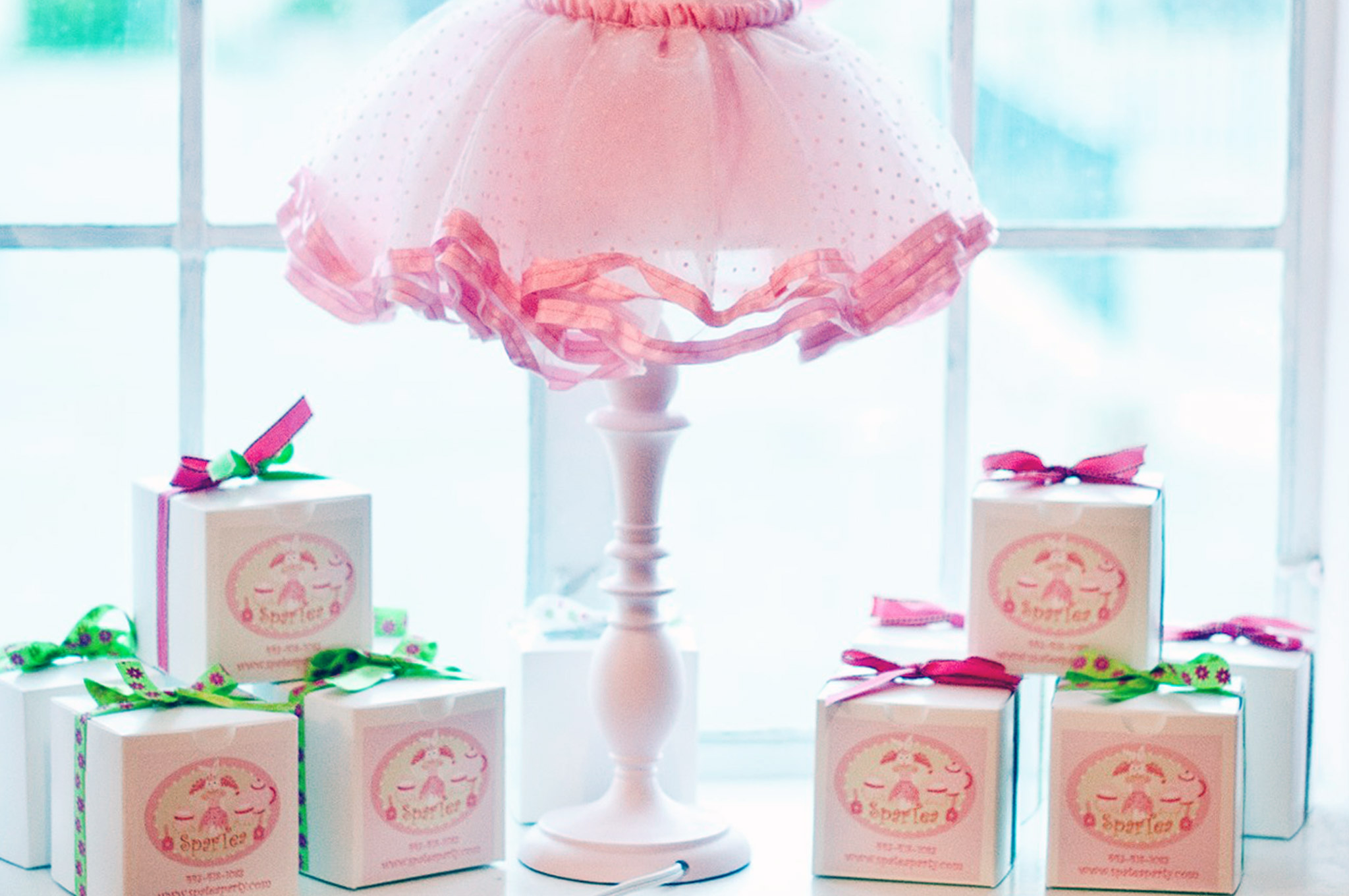 gift boxes under a lamp with a tutu looking lampshade