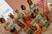 girls holding up their paintings