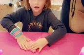 girl sitting at table playing with ultimate slime