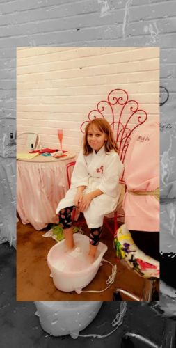 girl sitting with feet in foot spa
